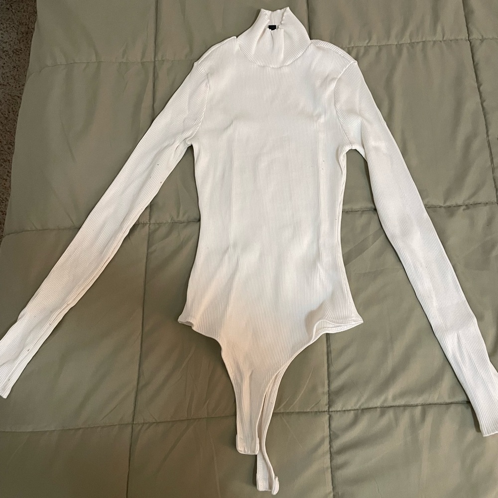 Lulu’s small, white, ribbed turtleneck bodysuit